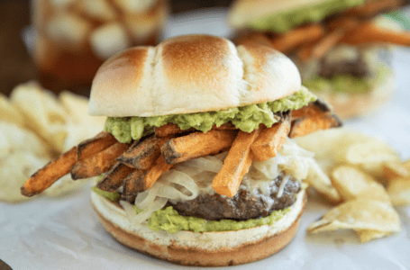 Burger Topped with Sweet Potato Fries and Beer Caramelized Onions